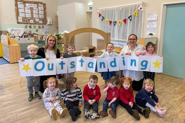 Deputy manager Hayley Rochford and manager Kathryn Pino celebrate the nursery's outstanding Ofsted with the children.