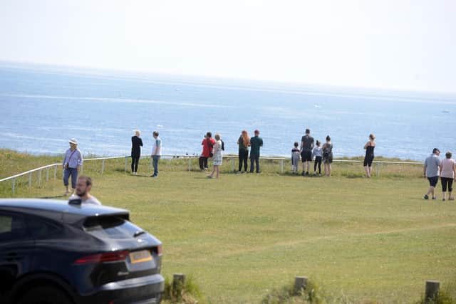 Walkers stop to watch the stunning sight.