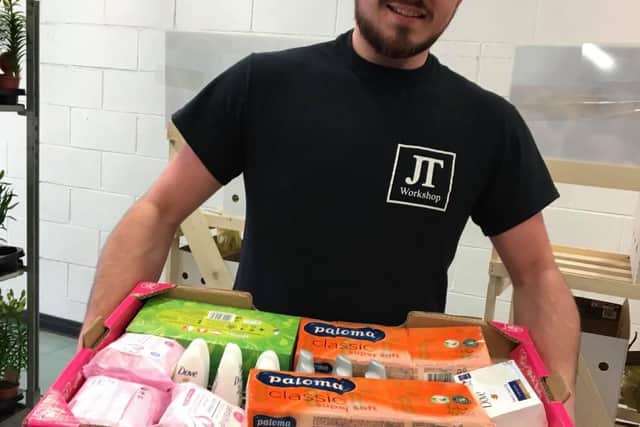 Josh Trueman has been making thousands of clips for carers. Pictured with a donation of toiletries to the NHS.