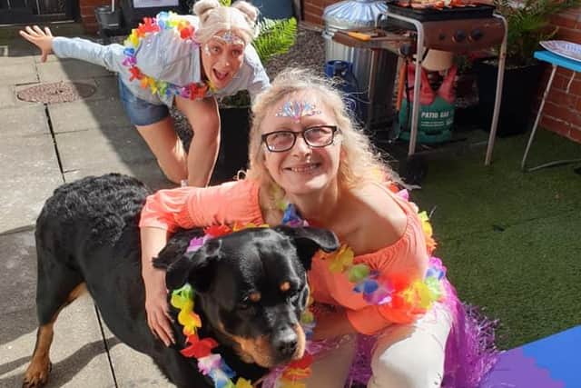 Rhonda and Jayne Edgar and Betty the dog enjoy Rosiefest from their own garden. Photo credit: Vikki Swinhoe