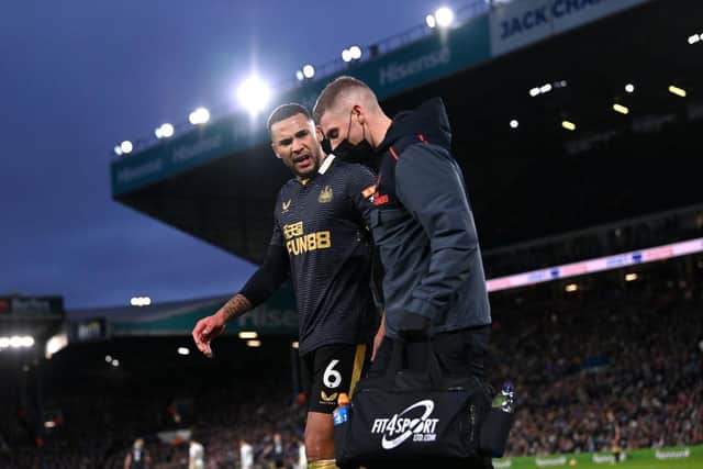Newcastle captain Jamaal Lascelles (l) leaves the field with an injury during the Premier League match between Leeds United  and  Newcastle United at Elland Road on January 22, 2022 in Leeds, England. (Photo by Stu Forster/Getty Images)