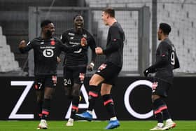 Lille's Dutch defender Sven Botman (2nd R) celebrates with Lille's French midfielder Jonathan Bamba (L), Lille's Belgian midfielder Amadou Onana (2nd L) and Lille's Canadian forward Jonathan David (R) after scoring a goal during the French L1 football match between Olympique Marseille (OM) and Lille OSC at the Velodrome Stadium in Marseille, southern France, on January 16, 2022. (Photo by SYLVAIN THOMAS/AFP via Getty Images)