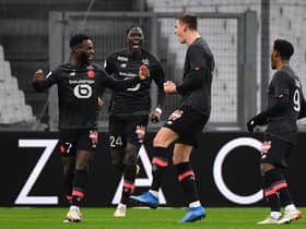 Lille's Dutch defender Sven Botman (2nd R) celebrates with Lille's French midfielder Jonathan Bamba (L), Lille's Belgian midfielder Amadou Onana (2nd L) and Lille's Canadian forward Jonathan David (R) after scoring a goal during the French L1 football match between Olympique Marseille (OM) and Lille OSC at the Velodrome Stadium in Marseille, southern France, on January 16, 2022. (Photo by SYLVAIN THOMAS/AFP via Getty Images)