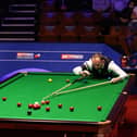 Mark Joyce lines up a shot during the Betfred World Snooker Championships 2021. Picture by PA