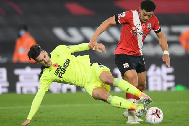 Fabian Schar tackles Che Adams.