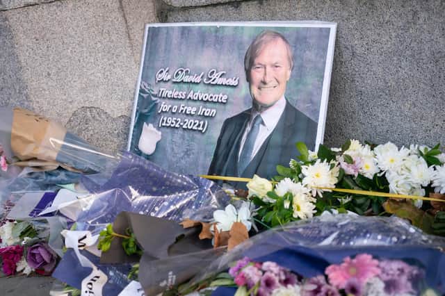 Flowers left in memory of Sir David Amess outside the Houses of Parliament, in Westminster, London. A