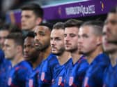 James Maddison and England substitute players line up for the national anthem prior to the FIFA World Cup Qatar 2022 Group B match between Wales and England at Ahmad Bin Ali Stadium on November 29, 2022 in Doha, Qatar. (Photo by Laurence Griffiths/Getty Images)