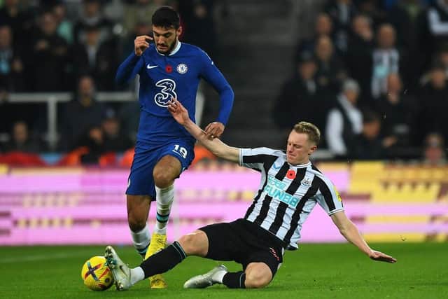 Chelsea's Albanian forward Armando Broja (L) vies with Newcastle United's English midfielder Sean Longstaff (R) during the English Premier League football match between Newcastle United and Chelsea at St James' Park in Newcastle-upon-Tyne, north east England on November 12, 2022. (Photo by ANDY BUCHANAN/AFP via Getty Images)