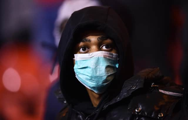 NOTTINGHAM, ENGLAND - MARCH 06: A fan wears a face mask as protection from Coronavirus during the Sky Bet Championship match between Nottingham Forest and Millwall at City Ground on March 06, 2020 in Nottingham, England. (Photo by Nathan Stirk/Getty Images)