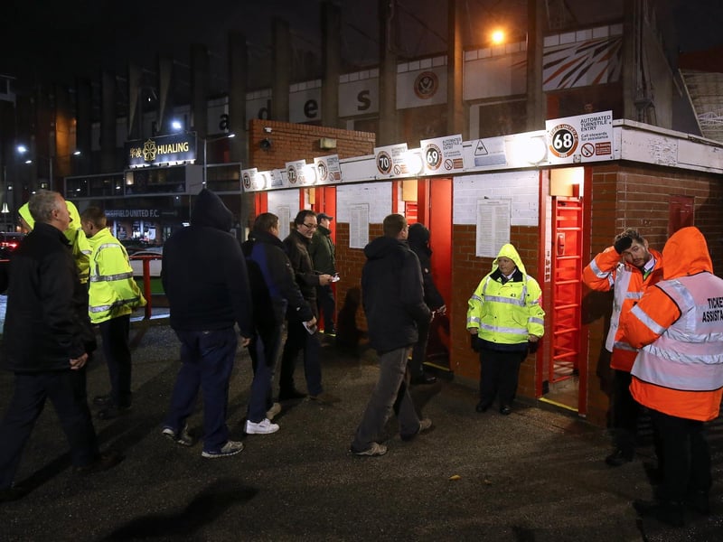 Supporters make their way through the turnstiles at Bramall Lane, Sheffield