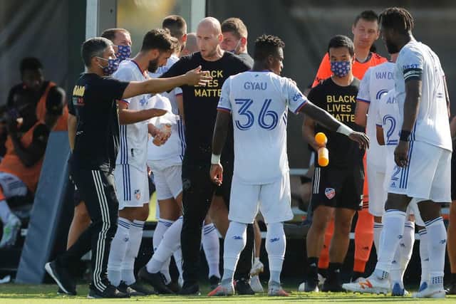 REUNION, FLORIDA - JULY 16: Head coach Jaap Stam of FC Cincinnati talks with Joseph-Claude Gyau #36 during a Group E match against Atlanta United as part of the MLS Is Back Tournament at ESPN Wide World of Sports Complex on July 16, 2020 in Reunion, Florida. (Photo by Michael Reaves/Getty Images)