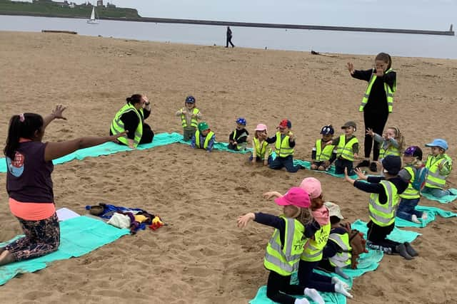 Nurserytime youngsters at full stretch on the beach.