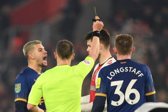 Duje Caleta-Car of Southampton is shown a red card by Referee Stuart Attwell, after fouling Allan Saint-Maximin of Newcastle United (not pictured), during the Carabao Cup Semi Final 1st Leg match between Southampton and Newcastle United at St Mary's Stadium on January 24, 2023 in Southampton, England. (Photo by Mike Hewitt/Getty Images)