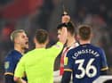 Duje Caleta-Car of Southampton is shown a red card by Referee Stuart Attwell, after fouling Allan Saint-Maximin of Newcastle United (not pictured), during the Carabao Cup Semi Final 1st Leg match between Southampton and Newcastle United at St Mary's Stadium on January 24, 2023 in Southampton, England. (Photo by Mike Hewitt/Getty Images)