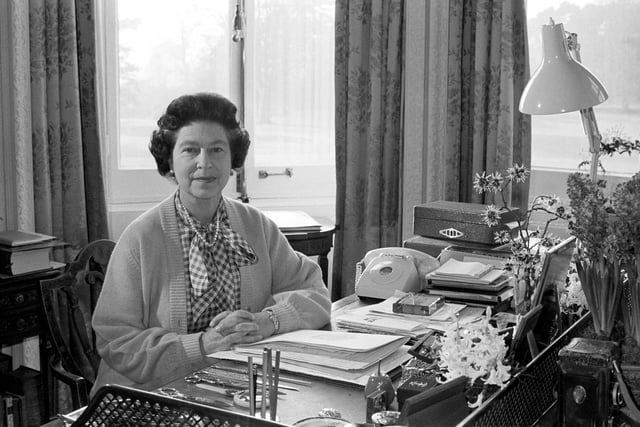 Queen Elizabeth II, at her desk in the study of Sandringham House, her Norfolk home, where she marked her 30th anniversary of her accession to the throne. 07/02/82