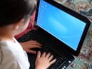 Young people spend more time online at earlier ages than ever before, and while the internet offers many positive opportunities, it can also pose a serious risk. Photo by Peter Byrne/PA Wire