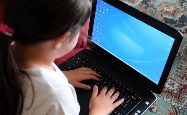 Young people spend more time online at earlier ages than ever before, and while the internet offers many positive opportunities, it can also pose a serious risk. Photo by Peter Byrne/PA Wire