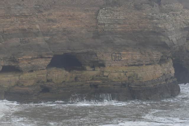 Graffiti sprayed onto the side of The Wherry cliffs at Whitburn.