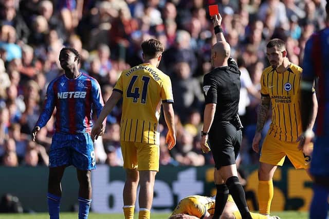 Referee Anthony Taylor shows a red card to Crystal Palace striker Eddie Nketiah