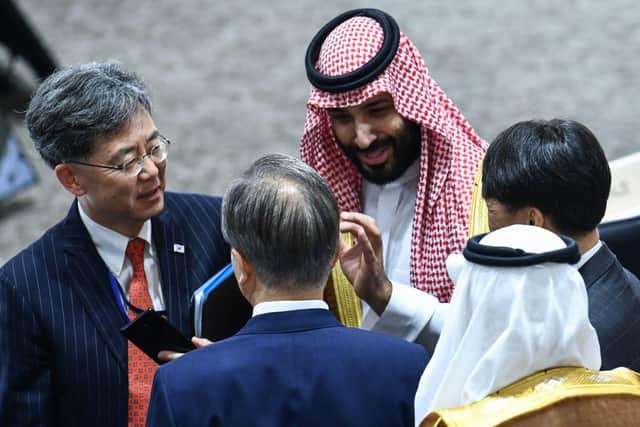 Saudi Arabia's Crown Prince Mohammed bin Salman (top) speaks with South Korea's President Moon Jae-in (C) during session 3 on women's workforce participation, future of work, and ageing societies during the G20 Summit in Osaka on June 29, 2019. (Photo by Brendan Smialowski / AFP)        (Photo credit should read BRENDAN SMIALOWSKI/AFP via Getty Images)