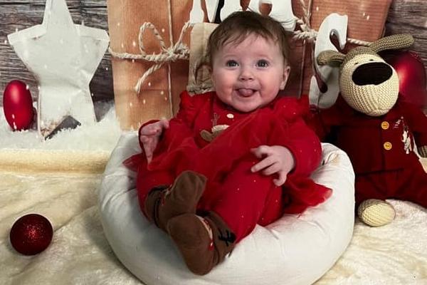 Robyn, age 6 months, ready to celebrate Christmas.