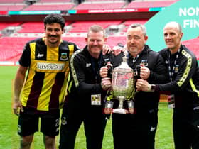 Hebburn Town manager Kevin Bolam (second right) celebrates with Angelos Eleftheriadis (left), coaches Michael Mulhern and Jason Miller (right) with the Buildbase FA Vase 2019/20 Trophy after victory in the Final at Wembley Stadium.
