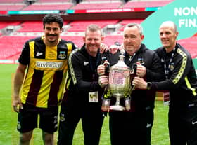 Hebburn Town manager Kevin Bolam (second right) celebrates with Angelos Eleftheriadis (left), coaches Michael Mulhern and Jason Miller (right) with the Buildbase FA Vase 2019/20 Trophy after victory in the Final at Wembley Stadium.