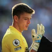 Newcastle United's English goalkeeper Nick Pope looks at his gloves during the English Premier League football match between Newcastle United and Manchester City at St James' Park in Newcastle-upon-Tyne, north east England, on August 21, 2022. (Photo by LINDSEY PARNABY/AFP via Getty Images)