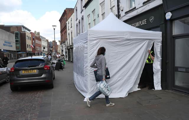 A police tent outside The Clean Plate cafe in Southgate Street, Gloucester. Picture date: Tuesday May 11, 2021.