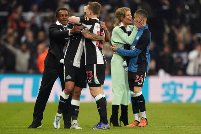 Newcastle United co-owner Amanda Staveley celebrates with Miguel Almiron as loanee Matt Targett embraces a team-mate in front of director Majed Al Sorour.