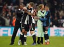 Newcastle United co-owner Amanda Staveley celebrates with Miguel Almiron as loanee Matt Targett embraces a team-mate in front of director Majed Al Sorour.