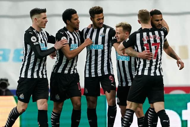 Newcastle United's English defender Jamaal Lascelles (R) celebrates with teammates after scoring the opening goal of the English Premier League football match between Newcastle United and Wolverhampton Wanderers at St James' Park in Newcastle-upon-Tyne, north east England on February 27, 2021.