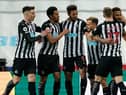 Newcastle United's English defender Jamaal Lascelles (R) celebrates with teammates after scoring the opening goal of the English Premier League football match between Newcastle United and Wolverhampton Wanderers at St James' Park in Newcastle-upon-Tyne, north east England on February 27, 2021.