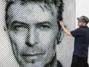 Artist Joe Black adds the finishing touches to a portrait of David Bowie made from over 8,500 guitar plectrums, commissioned by Sky Arts to celebrate Bowie topping a new definitive list of Britain's 50 most influential artists of the past 50 years