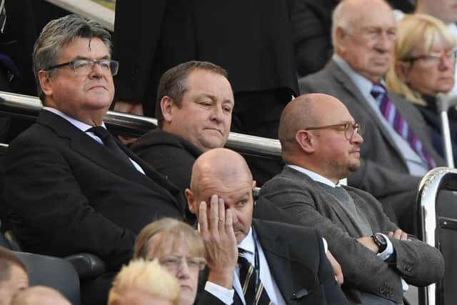 NEWCASTLE UPON TYNE, ENGLAND - SEPTEMBER 29:  Newcastle owner Mike Ashley (c) flanked by Keith Bishop (l) and Lee Charnley look on from the stand during the Premier League match between Newcastle United and Leicester City at St. James Park on September 29, 2018 in Newcastle upon Tyne, United Kingdom.  (Photo by Stu Forster/Getty Images)