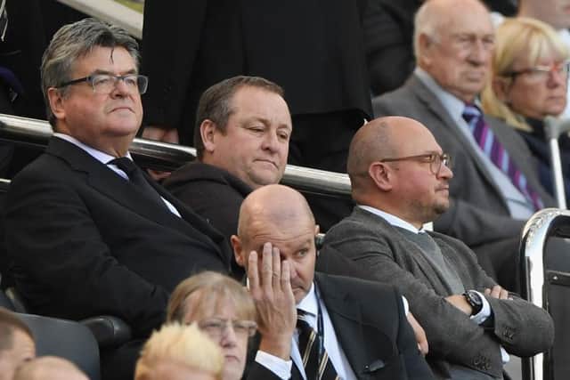 NEWCASTLE UPON TYNE, ENGLAND - SEPTEMBER 29: Newcastle owner Mike Ashley (c) flanked by Keith Bishop (l) and Lee Charnley look on from the stand during the Premier League match between Newcastle United and Leicester City at St. James Park on September 29, 2018 in Newcastle upon Tyne, United Kingdom. (Photo by Stu Forster/Getty Images)