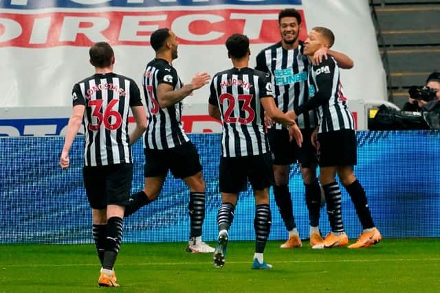 Newcastle United's English striker Dwight Gayle (R) celebrates with teammates after scoring their second goal during the English Premier League football match between Newcastle United and West Bromwich Albion at St James' Park in Newcastle-upon-Tyne, north east England on December 12, 2020.