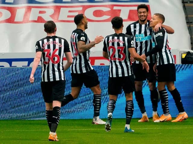Newcastle United's English striker Dwight Gayle (R) celebrates with teammates after scoring their second goal during the English Premier League football match between Newcastle United and West Bromwich Albion at St James' Park in Newcastle-upon-Tyne, north east England on December 12, 2020.