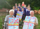 Hebburn Lakes Primary School donation of 100 poppies to Bedewell Grange Care Home. Residents Meg Ord and Bernard Johnson.