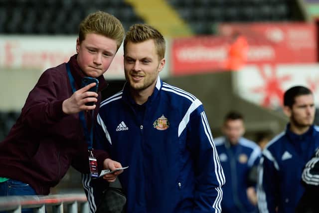 SWANSEA, WALES - FEBRUARY 07: Sunderland player Sebastian Larsson has his picture taken with a fan before the Barclays Premier League match between Swansea City and Sunderland at Liberty Stadium on February 7, 2015 in Swansea, Wales. (Photo by Stu Forster/Getty Images)