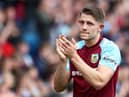 James Tarkowski of Burnley applauds the fans following defeat and relegation to the Sky Bet Championship following the Premier League match between Burnley and Newcastle United at Turf Moor on May 22, 2022 in Burnley, England. (Photo by Jan Kruger/Getty Images)