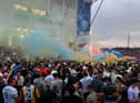 Leeds United supporters gather outside their Elland Road ground to celebrate the club's return to the Premier League after a gap of 16 years, in Leeds, northern England on July 17, 2020. - Leeds United were promoted to the Premier League on Friday after West Bromwich Albion's 2-1 defeat at Huddersfield ensured the Championship leaders will end their 16-year exile from the top-flight.