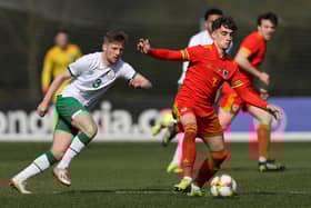 Niall Huggins of Wales U 21 controls the ball watched by Mason O'Malley of the Republic of Ireland U 21 during the International Friendly match between Wales U21 and Republic of Ireland U21 at Colliers Park on March 26, 2021 in Wrexham, Wales. (Photo by Clive Brunskill/Getty Images)