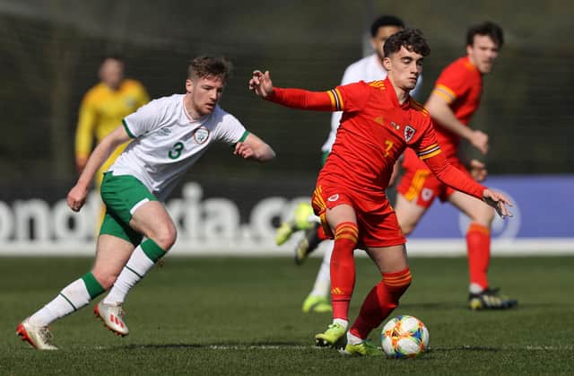 Niall Huggins of Wales U 21 controls the ball watched by Mason O'Malley of the Republic of Ireland U 21 during the International Friendly match between Wales U21 and Republic of Ireland U21 at Colliers Park on March 26, 2021 in Wrexham, Wales. (Photo by Clive Brunskill/Getty Images)