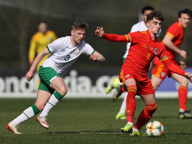 Niall Huggins of Wales U 21 controls the ball watched by Mason O'Malley of the Republic of Ireland U 21 during the International Friendly match between Wales U21 and Republic of Ireland U21 at Colliers Park on March 26, 2021 in Wrexham, Wales. (Photo by Clive Brunskill/Getty Images)