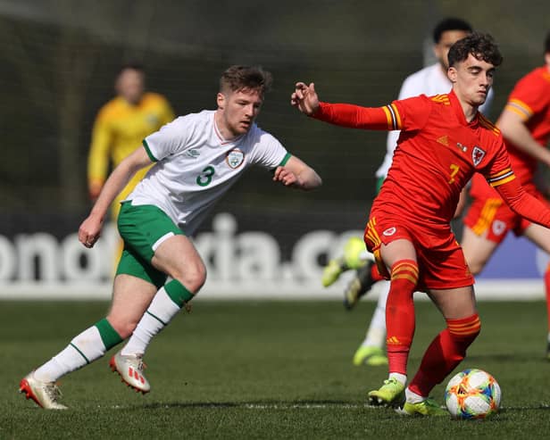 Niall Huggins of Wales U 21 controls the ball watched by Mason O'Malley of the Republic of Ireland U 21 during the International Friendly match between Wales U21 and Republic of Ireland U21 at Colliers Park on March 26, 2021 in Wrexham, Wales. (Photo by Clive Brunskill/Getty Images)