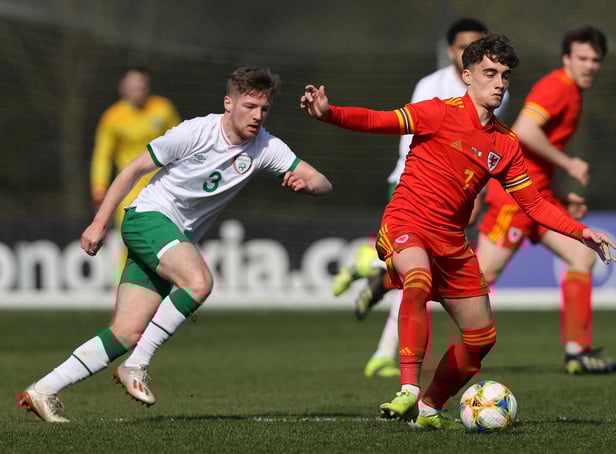 Niall Huggins of Wales U 21 controls the ball watched by Mason O'Malley of the Republic of Ireland U 21 during the International Friendly match between Wales U21 and Republic of Ireland U21 at Colliers Park on March 26, 2021 in Wrexham, Wales. (Photo by Clive Brunskill/Getty Images)
