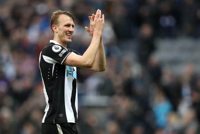 NEWCASTLE UPON TYNE, ENGLAND - FEBRUARY 13: Dan Burn of Newcastle United applauds the fans following victory in the Premier League match between Newcastle United and Aston Villa at St. James Park on February 13, 2022 in Newcastle upon Tyne, England. (Photo by George Wood/Getty Images)