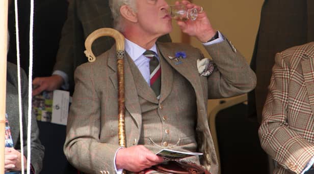 King Charles III enjoys a dram during the Mey Highland Games at the John O'Groats Showground in Caithness. Photo by Robert MacDonald/PA Wire