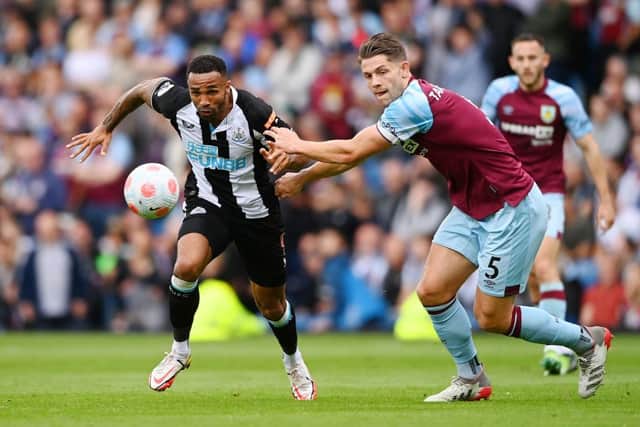 Callum Wilson of Newcastle United battles for possession with James Tarkowski of Burnley during the Premier League match between Burnley and Newcastle United at Turf Moor on May 22, 2022 in Burnley, England. (Photo by Gareth Copley/Getty Images)